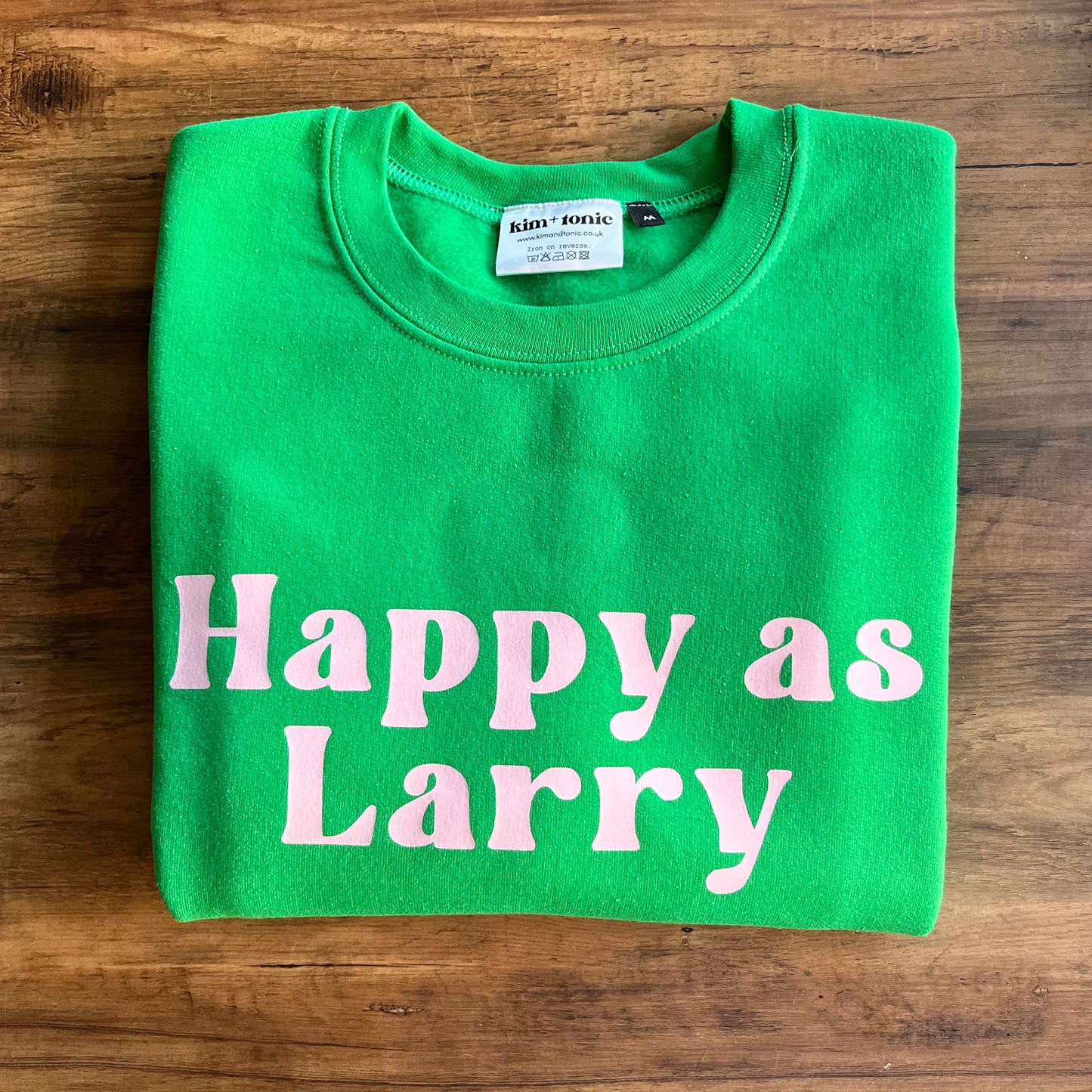 HAPPY AS LARRY SWEATSHIRT. Green with pink print.