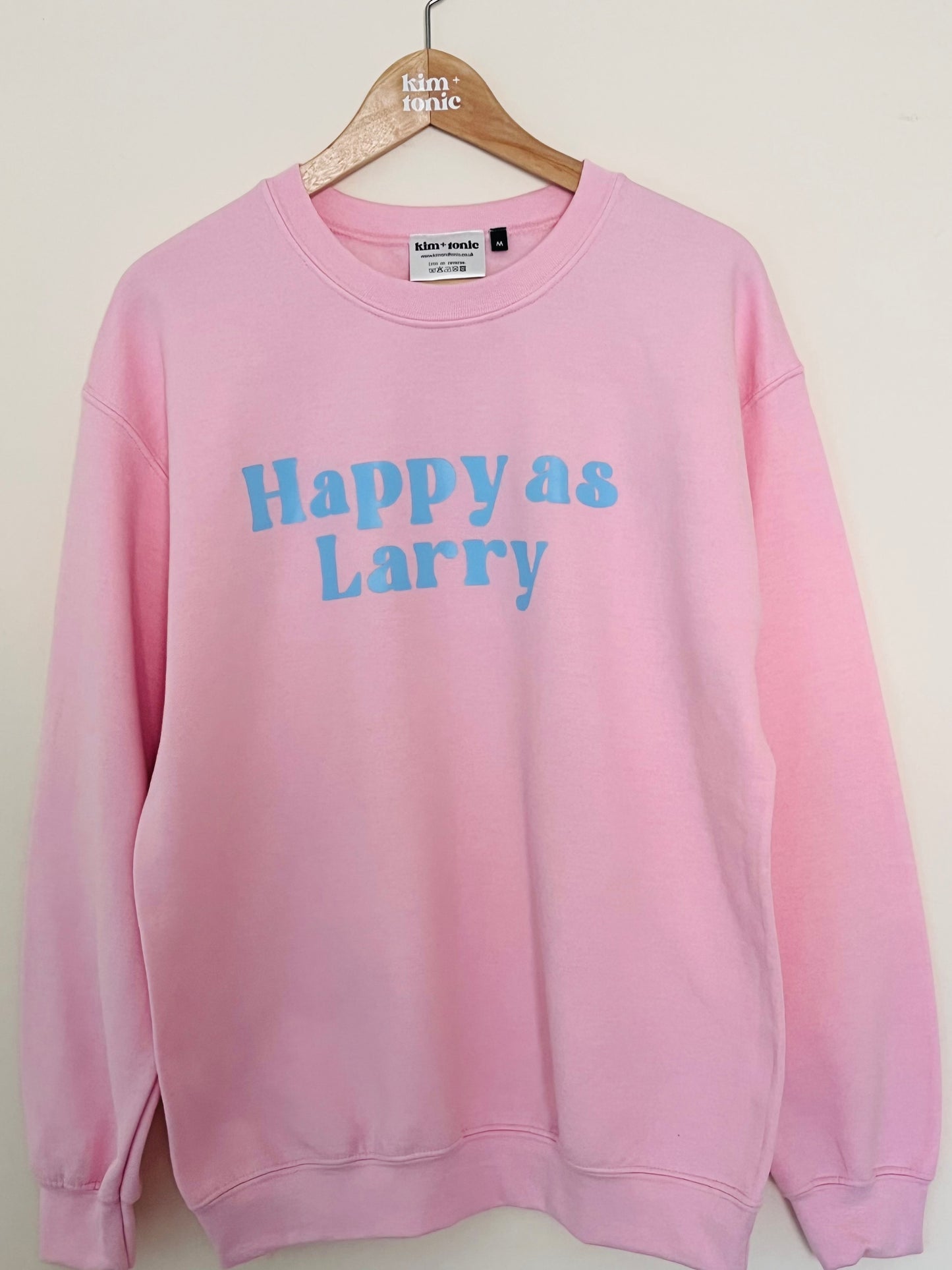 HAPPY AS LARRY SWEATSHIRT. Pink with blue print.