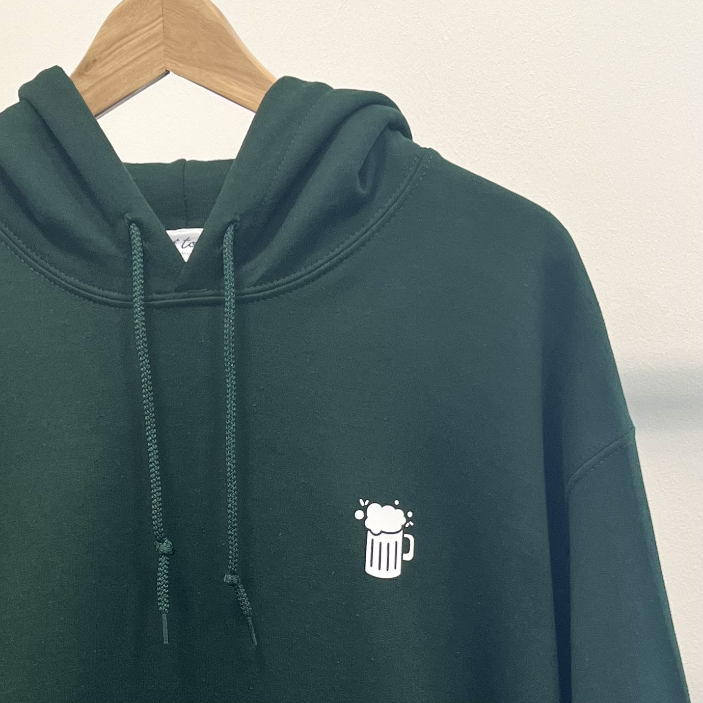 BIG WALK THEN PUB HOODIE. Dark green with white print.
