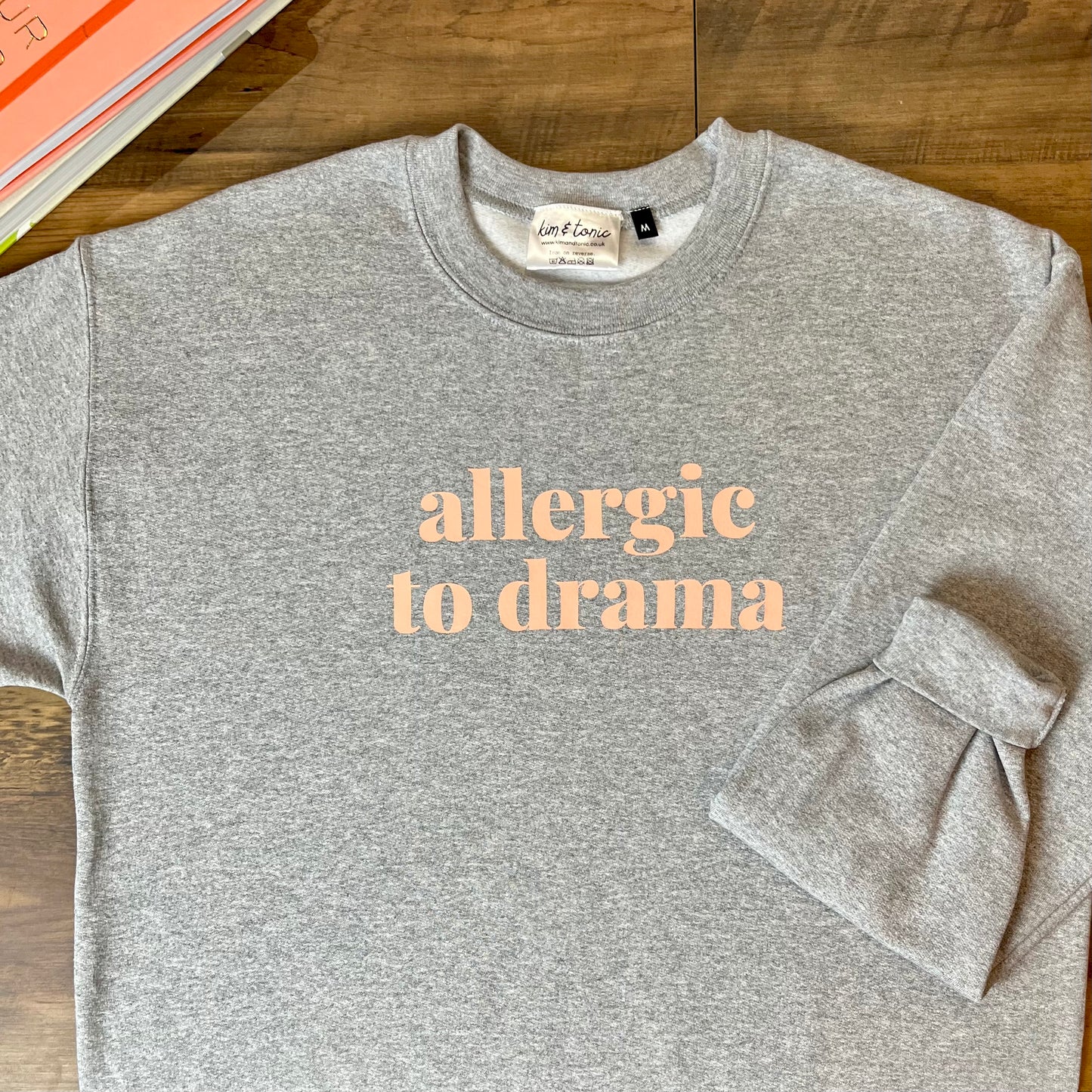 ALLERGIC TO DRAMA SWEATSHIRT. Grey with peach print.