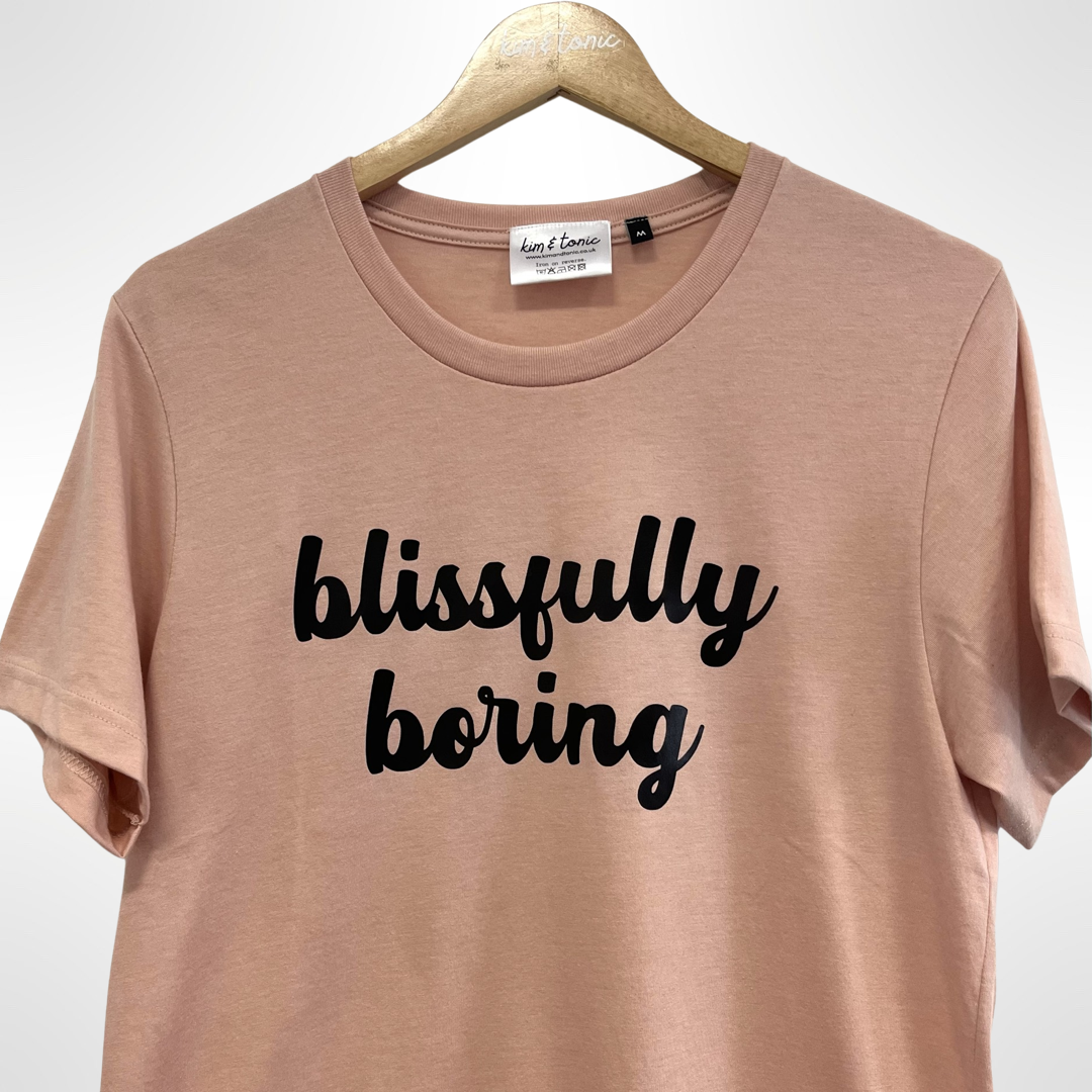 BLISSFULLY BORING T-SHIRT. Peach with black print.