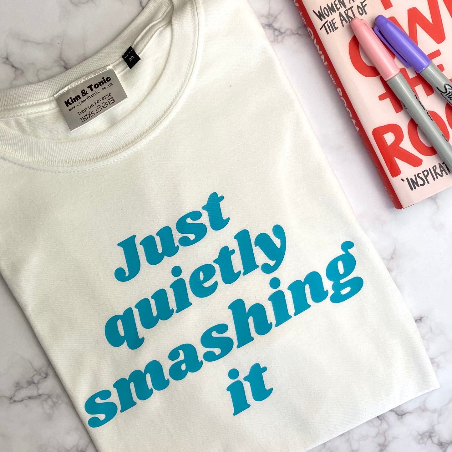 JUST QUIETLY SMASHING IT T-shirt. White with teal print.