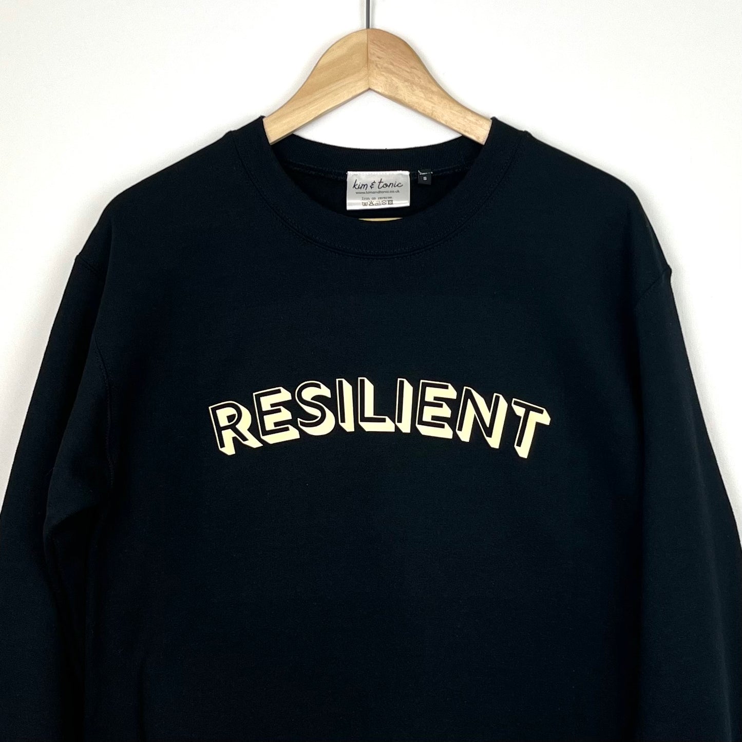 RESILIENT SWEATSHIRT. Black with cream print.